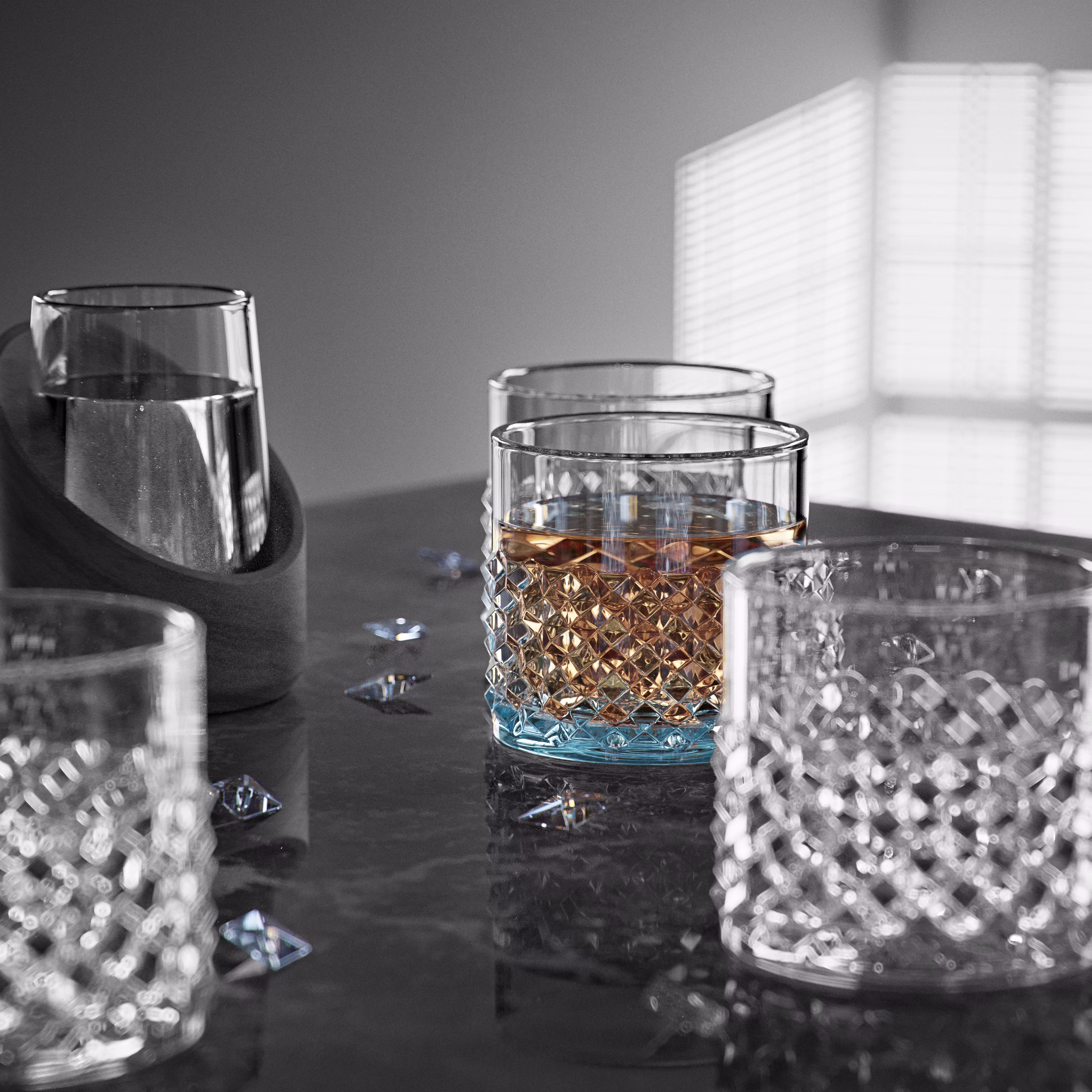 A 3D render of glass cups where one is filled